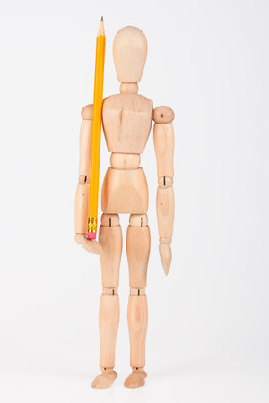 Small wood mannequin standing with colour pencil isolated on white backgroundの写真素材