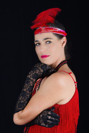 Young beautiful brunette in 1920 style attire red dress and feathery
