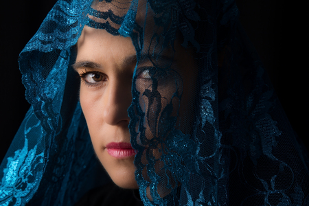 Middle Eastern woman portrait looking sad with a blue hijab artistic conversionの写真素材