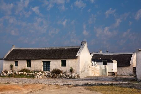 Old white fisherman house with reed roof in Arniston, South Africaのeditorial素材