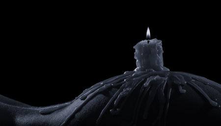 Body scape of a woman with burning candle and on her buttock artistic conversionの写真素材