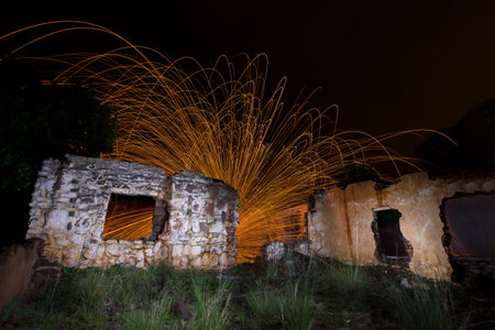 Light painting in abandon house with spinning steel wool making fireの写真素材