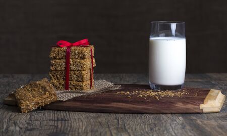 Stack of oatmeal crunchy cookies and milk in the backgroundの写真素材