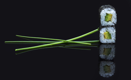 Sushi arranged on a shiny black surface looking very deliciousの写真素材
