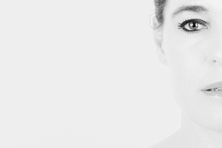 High key portrait of a woman with only a half of her faceの写真素材