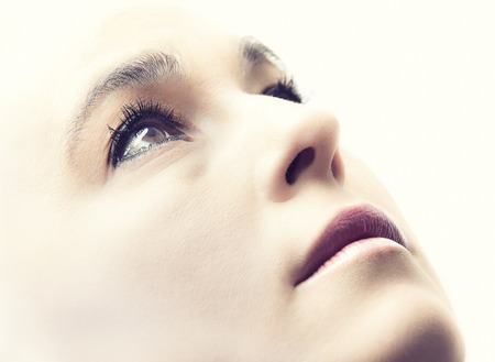 High key portrait of a woman with an empty expression on her faceの写真素材