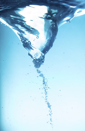 Blue water spiral of water swirling around in a studioの写真素材