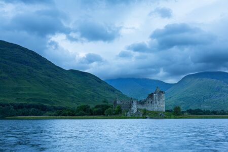 Kilchurn Castle in the Scottish Highlands landscape from across the lakeの写真素材