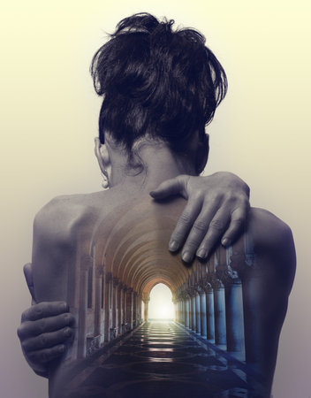 Double exposure image of a woman portrait with hallway going through her backの写真素材