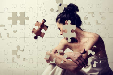 Jigsaw puzzle of a mature brunette woman sitting and contemplates the realities of lifeの写真素材