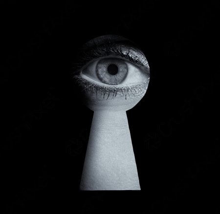 A surreal black and white image of a human eye peering through a keyhole, symbolizing surveillance,...