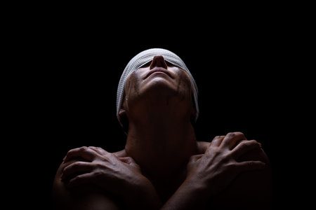 A woman behind metal bars reaches out with tear-filled eyes, her face marked with pain and longing