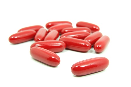 Red pills isolated on white background の写真素材