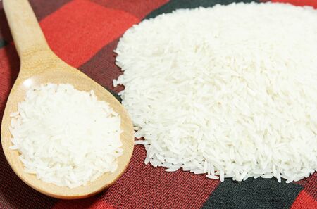 rice grain and wooden spoonの写真素材