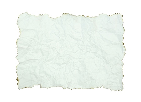 crumpled paper with burnt edges over whiteの写真素材