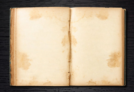 old book open on dark wood background