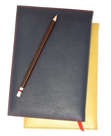 stack of leather notebook and pencil isolated on white の写真素材