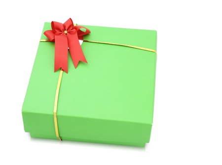 Green gift box with red ribbon bow isolated on white backgroundの写真素材