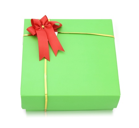 Green gift box with red ribbon bow isolated on white backgroundの写真素材