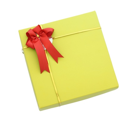 Gold gift box with red ribbon bow isolated on white with clipping pathの写真素材