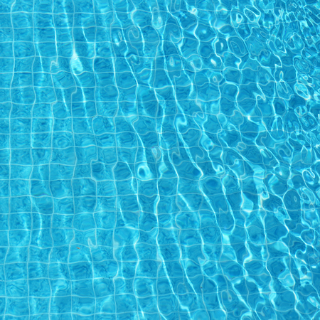 Blue rippled water background in swimming pool の写真素材