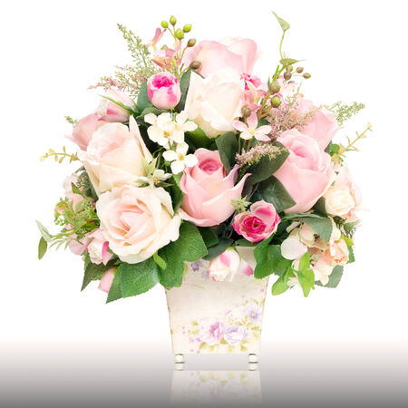 artificial rose flower pot isolated on whiteの写真素材