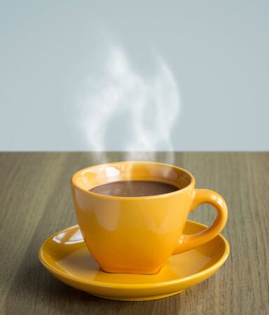 steaming coffee cup on tableの写真素材