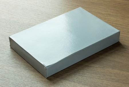 blank gray paper box on dark wood backgroundの写真素材