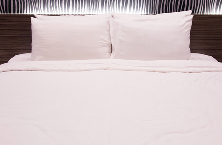 white pillow on the bedの写真素材