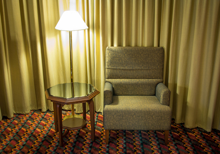 Sofa and lamp with table in the bedroom at night timeの写真素材