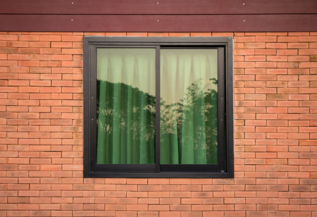 front view of window exterior on brick wallの写真素材