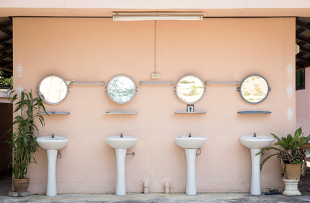 hand washing basin in public toiletの写真素材