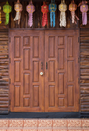 front view of entrance wood carved door, thai styleの写真素材