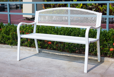 empty long white metal chair in the park outdoorの写真素材