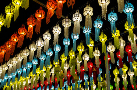 colorful hanging lanterns lighting on night sky in loy krathong festival at northern of thailandの写真素材