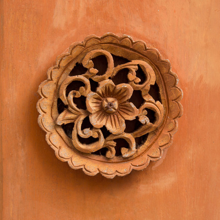 Circle flower carved on wood background for decoration, Traditional Thai style patternの写真素材