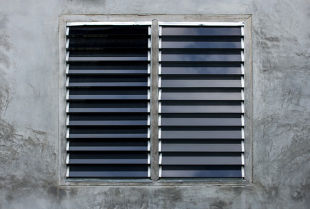 Louver window on gray concrete wallの写真素材
