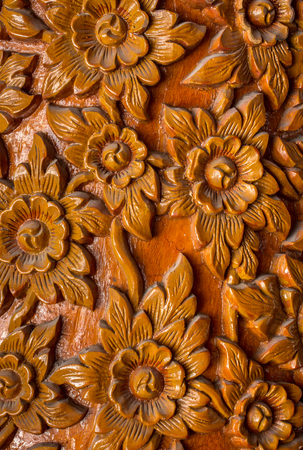 Pattern of flower carved on wood background. Traditional Thai style patternの写真素材