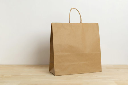 brown paper bag on wooden table for mockup blank template