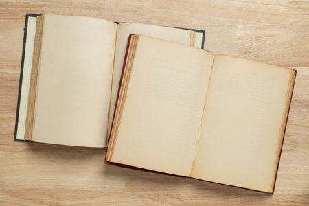 two open old book on wooden table for mockup blank template