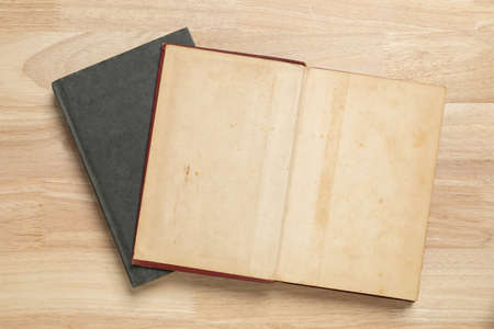 stack of open old book on wooden table for mockup blank templateの写真素材