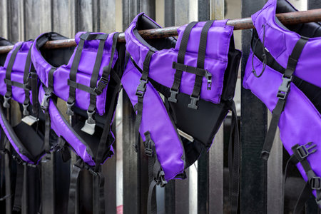 blue life jacket or life vest clothes for safety device hanging on a steel railの写真素材