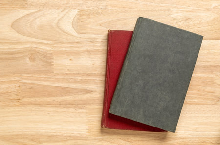 Stack of old book on wooden table for blank template