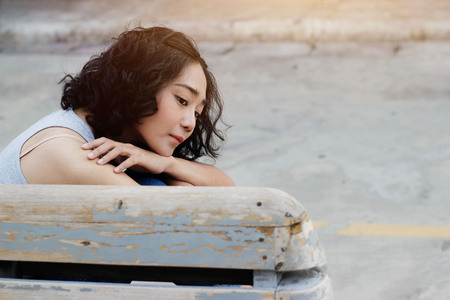 Portrait of a longing woman looking outdoors on vintage backgroundの写真素材