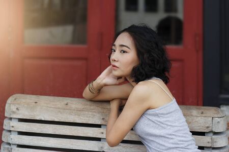 Portrait of a longing woman looking outdoors on vintage backgroundの写真素材