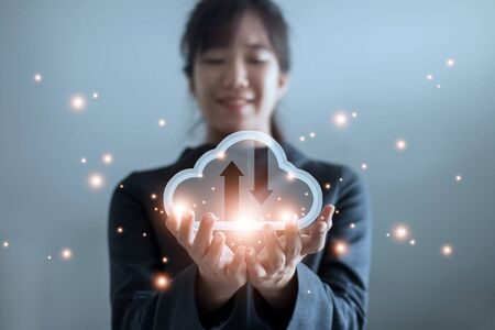 Cloud computing and technology concept. Palm hands of Business woman holding icon cloud computing network and data information.の写真素材