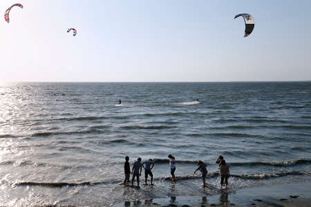 The young people  were playing on the beachの写真素材