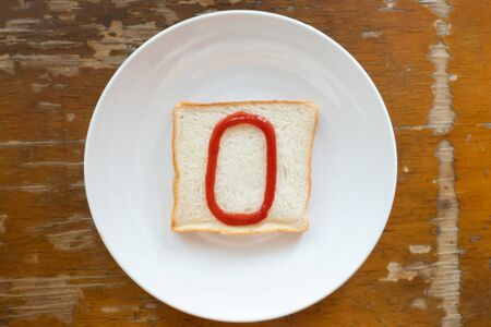bread of breakfast is written number 0 by ketchup on write plate. A to Z and Number and Special characters set.の写真素材