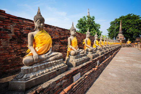buddhist statue with clear blue sky background in the old temple in Thailandの写真素材
