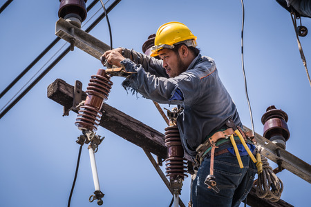 Electrician working on the electricity poleのeditorial素材